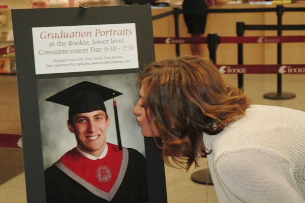 Hannah checks out Adam's Graduation Portrait Ad at the Bookie